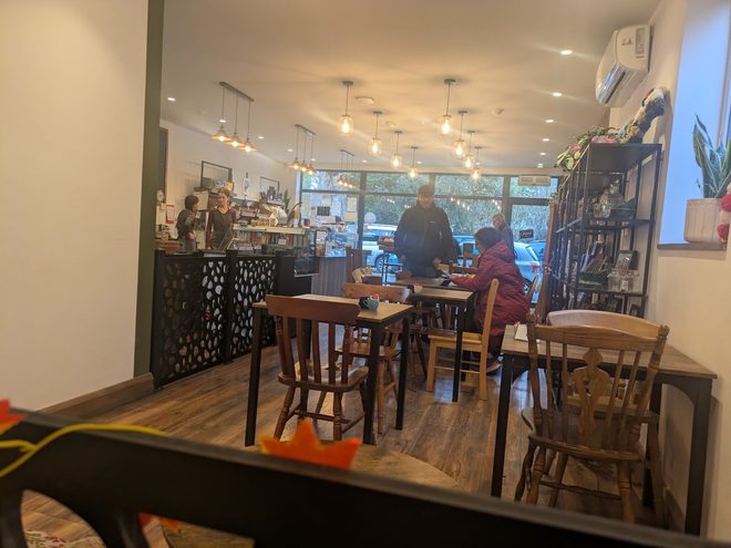 A busy afternoon in the café, seen past a foreground table