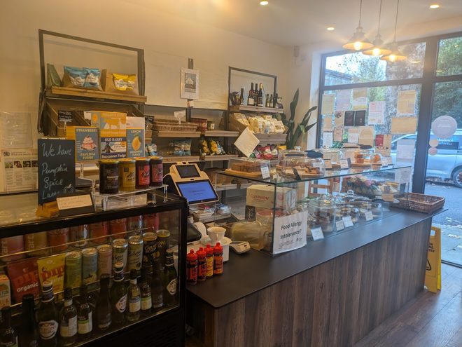 The till and deli counter with retail shelves behind