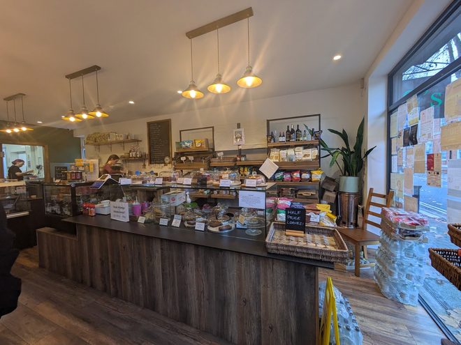 The cake display running the length of the timber counter