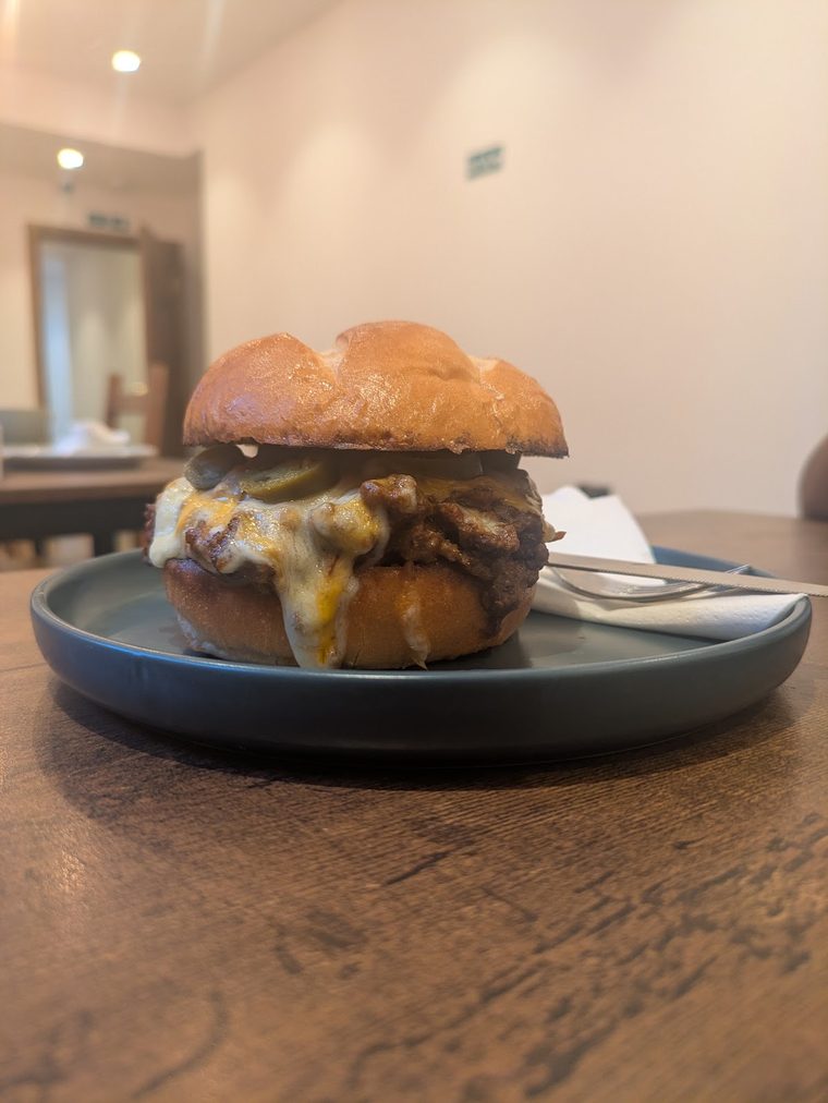 Brioche-bun cheeseburger on a dark plate